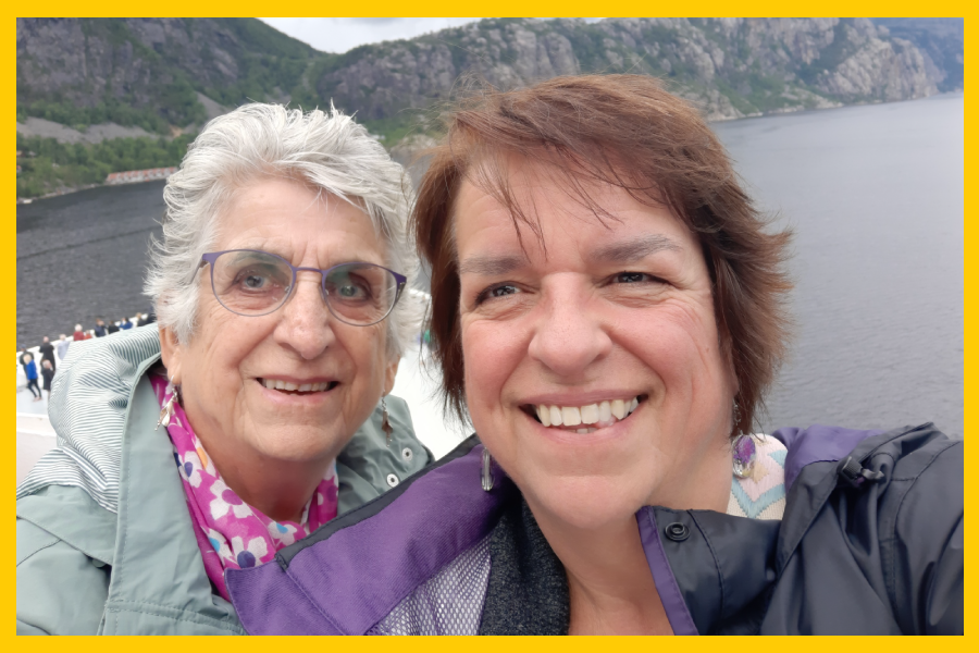 A close up of Maureen and her daughter Petra. They are outside, wearing coats. They are smiling.